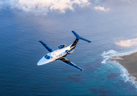 Light private jet flying over open ocean during cruise flight