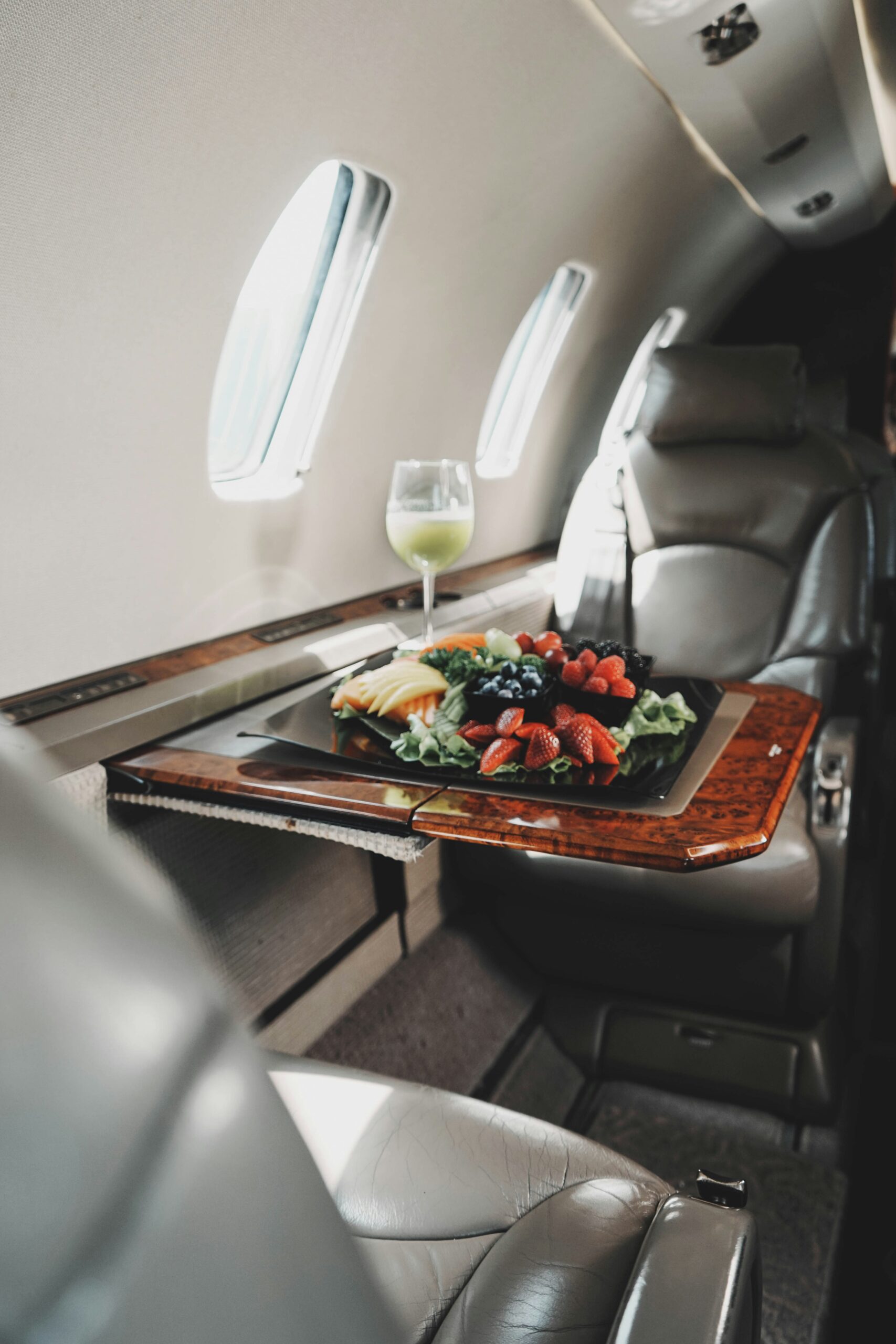 Private jet cabin with luxury seating and fresh food service onboard