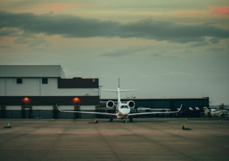 Private jet range aircraft parked near a hangar before departure