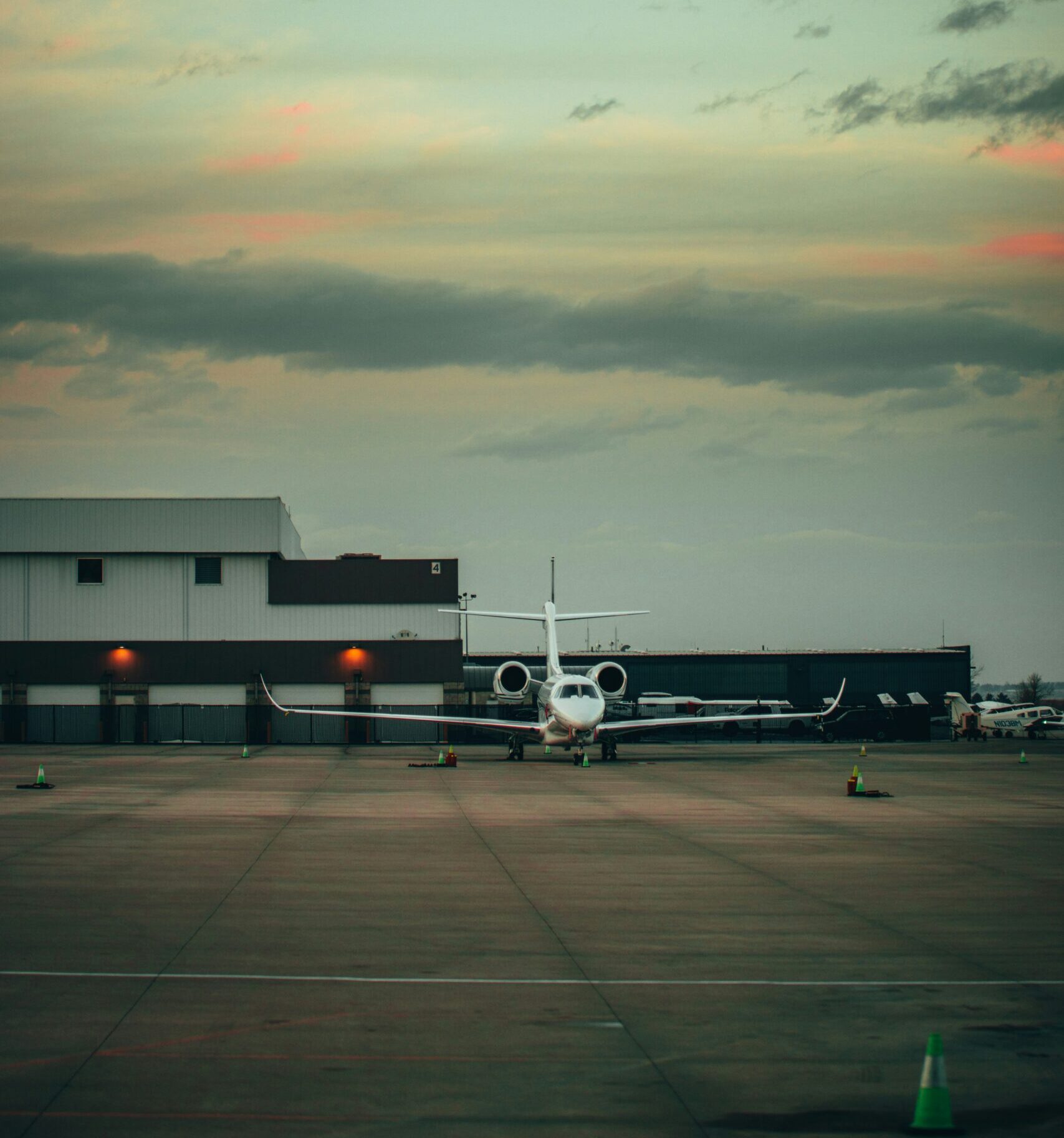 Private jet range aircraft parked near a hangar before departure