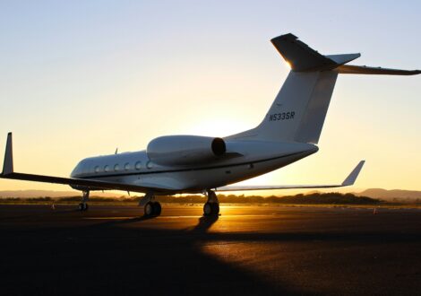 Private jet on the runway at sunset before a business flight