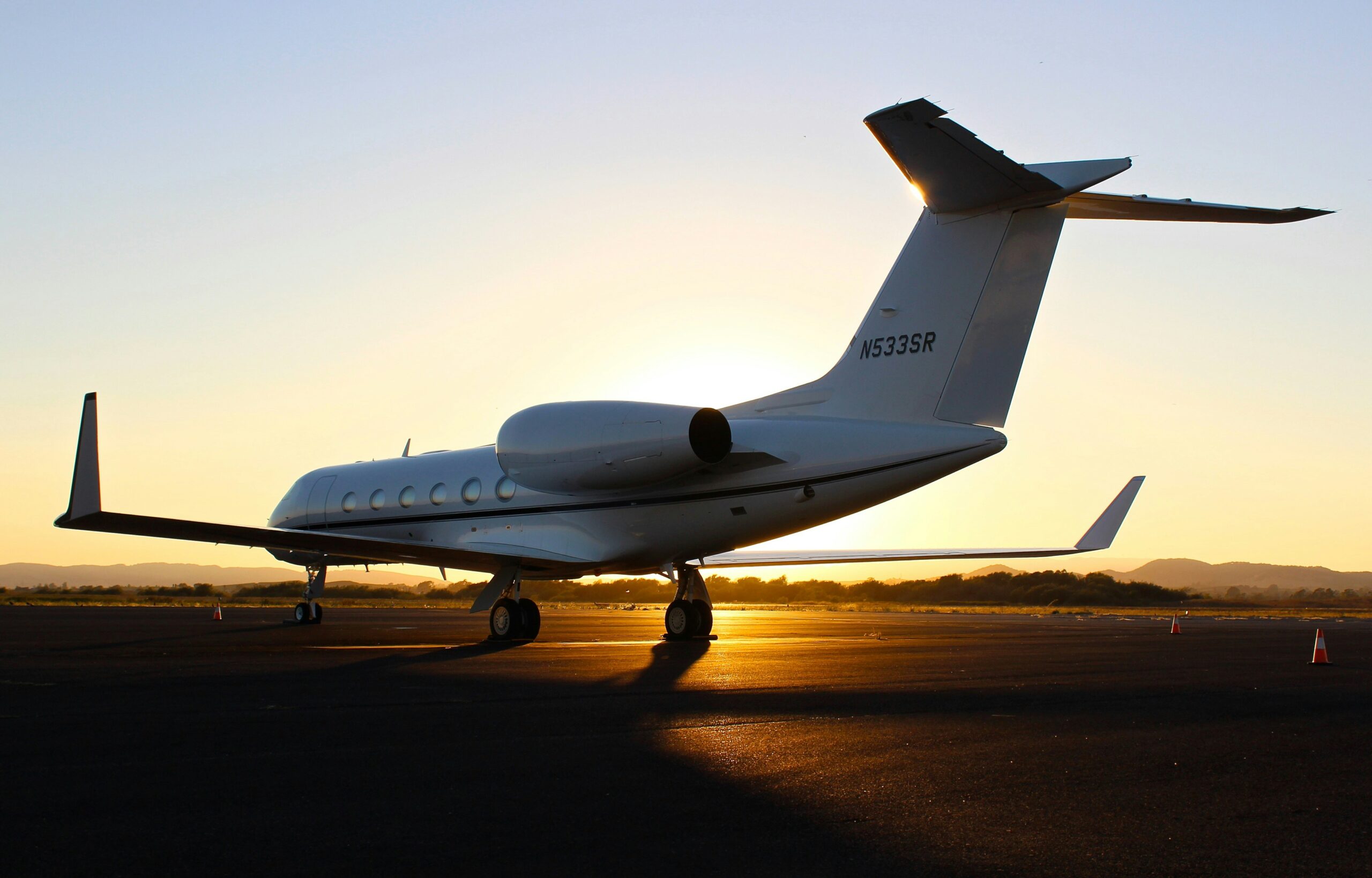 Private jet on the runway at sunset before a business flight
